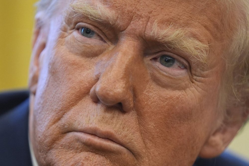 President Donald Trump listens to a question as he signs executive orders in the Oval Office at the White House, Thursday, Jan. 30, 2025, in Washington. Trump has said he will impose a 25 per cent tariff on Canadian goods as early as Saturday. THE CANADIAN PRESS/AP/Evan Vucci
