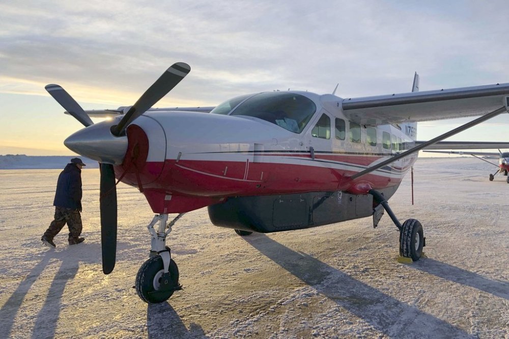 FILE - This Jan. 18, 2020, photo shows people preparing to get on an airplane at the airport in Bethel, Alaska, for a flight to Toksook Bay. (AP Photo/Mark Thiessen, File)