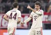 Bayern's Thomas Muller, right, celebrates after scoring the opening goal with Josip Stanisic during the Champions League opening phase soccer match between Bayern Munich and Slovan Bratislava at the Allianz Arena in Munich, Germany, Jan. 29, 2025. (Sven Hoppe/dpa via AP)