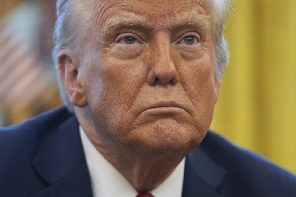 President Donald Trump listens to a question as he signs executive orders in the Oval Office at the White House, Thursday, Jan. 30, 2025, in Washington. THE CANADIAN PRESS/AP-Evan Vucci