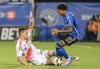 New England Revolution's Will Sands, left, slides in on CF Montreal's Jahkeele Marshall-Rutty (11) during second half MLS soccer action in Montreal, Saturday, August 24, 2024. THE CANADIAN PRESS/Graham Hughes