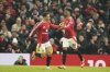 Manchester United's Amad Diallo, right, celebrates with Antony after scoring his side's first goal during the English Premier League soccer match between Manchester United and Southampton at the Old Trafford stadium in Manchester, England, Thursday, Jan. 16, 2025. (AP Photo/Dave Thompson)
