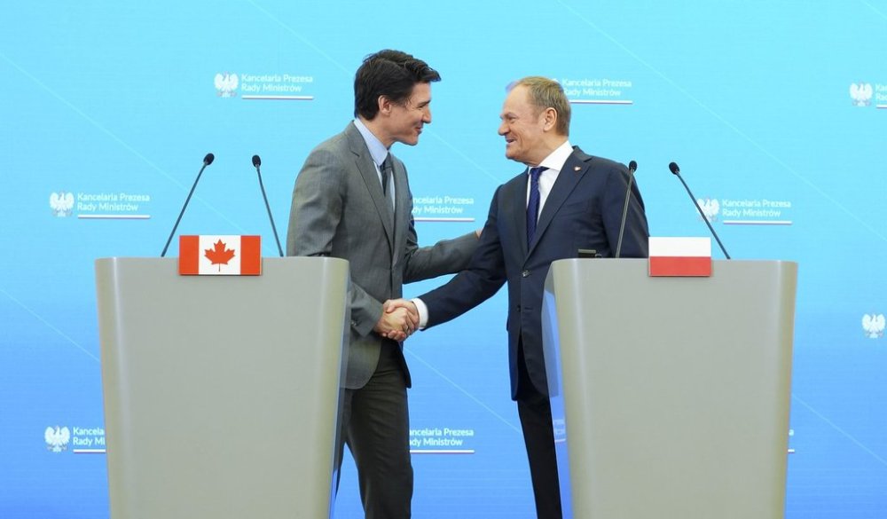 Prime Minister Justin Trudeau and Polish Prime Minister Donald Tusk shake hands after taking part in a joint press conference at the Chancellery of the Prime Minister in Warsaw, Poland on Tuesday, Jan. 28, 2025. THE CANADIAN PRESS/Sean Kilpatrick