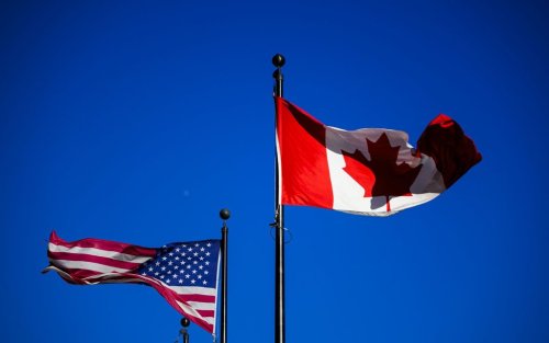 The flags of Canada and the United States fly outside a hotel in downtown Ottawa, Saturday, Feb. 1, 2025. THE CANADIAN PRESS/Justin Tang