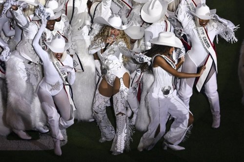 FILE - Beyoncé, center, is joined by her daughter Blue Ivy, right, during a halftime performance in an NFL football game between the Baltimore Ravens and the Houston Texans, Dec. 25, 2024, in Houston. (AP Photo/Maria Lysaker, File))