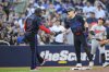 Toronto Blue Jays outfielder Daulton Varsho (25) celebrates with Jays third base coach Carlos Febles (51) after hitting an RBI triple during an MLB game against the Baltimore Orioles in Toronto on Monday, June 3, 2024. THE CANADIAN PRESS/Christopher Katsarov