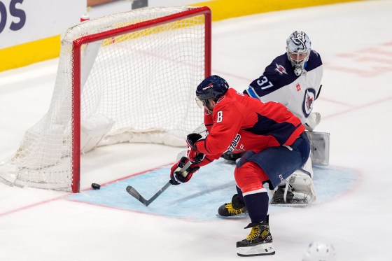 Washington Capitals left wing Alex Ovechkin (8) scores past Winnipeg Jets goaltender Connor Hellebuyck (37) in the March 24, 2024 game. The two teams face off tonight in Washington. (Mark Schiefelbein / Associated Press files)