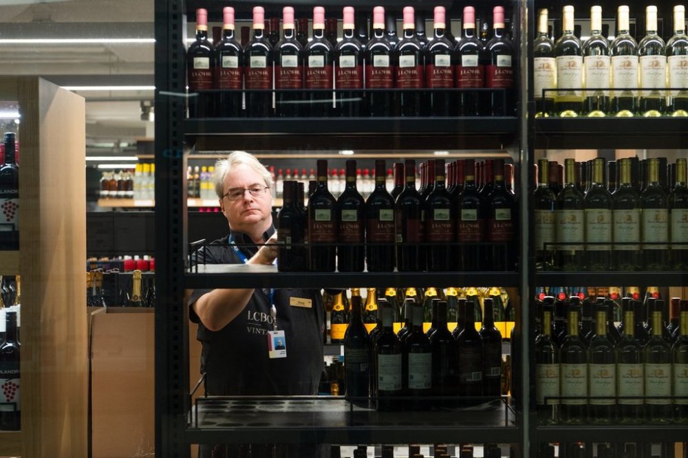 An LCBO employee moves products in an LCBO store at Union Station in Toronto on Tuesday, March 4, 2025. THE CANADIAN PRESS/Laura Proctor