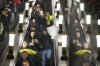 People go down the escalator in the subway with bunches of flowers purchased from the flower market on the eve of an International Women's Day, in Moscow, Russia, on Friday, March 7, 2025. (AP Photo/Alexander Zemlianichenko)