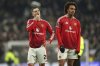 Manchester United's Diogo Dalot, left, and Joshua Zirkzee react after the English Premier League soccer match between Tottenham Hotspur and Manchester United in London, Sunday, Feb. 16, 2025. (AP Photo/Ian Walton)
