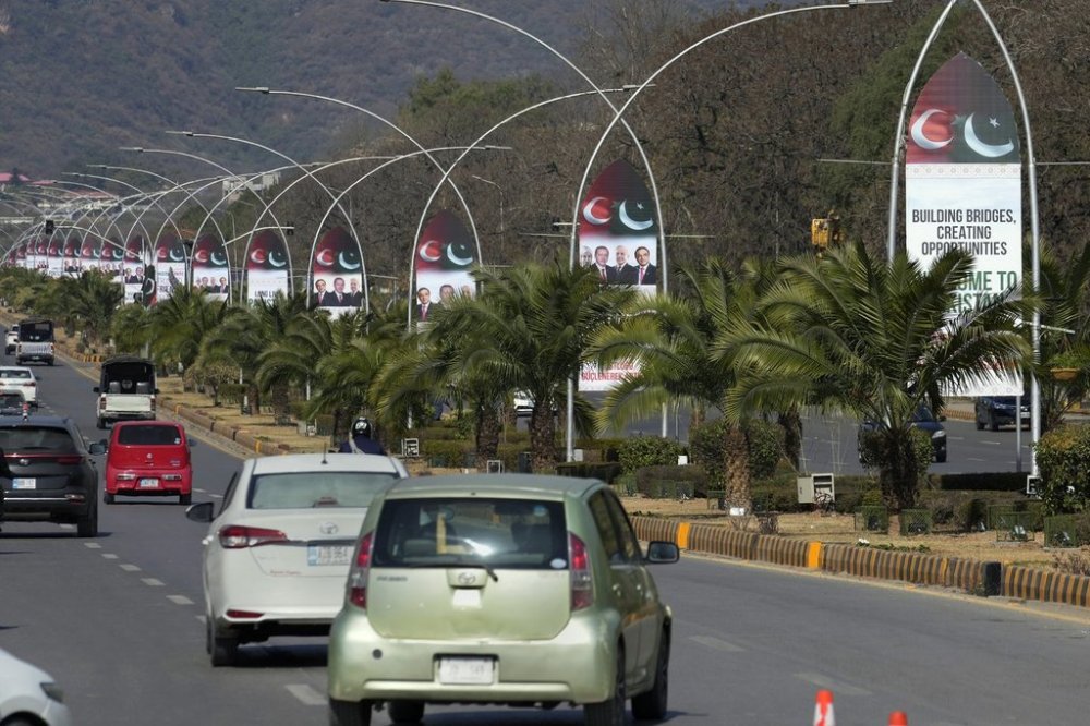 Vehicles drive past welcoming billboards with the pictures of Turkish President Recep Tayyip Erdogan, Pakistan's President Asif Ali Zardari and Prime Minister Shehbaz Sharif display on a road in Islamabad, Pakistan, Wednesday, Feb. 12, 2025. (AP Photo/Anjum Naveed)