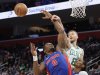 Boston Celtics center Kristaps Porzingis (8) passes the ball past Detroit Pistons center Jalen Duren (0) with forward Ausar Thompson looking on during the first half of an NBA basketball game Wednesday, Feb. 26, 2025, in Detroit. (AP Photo/Duane Burleson)