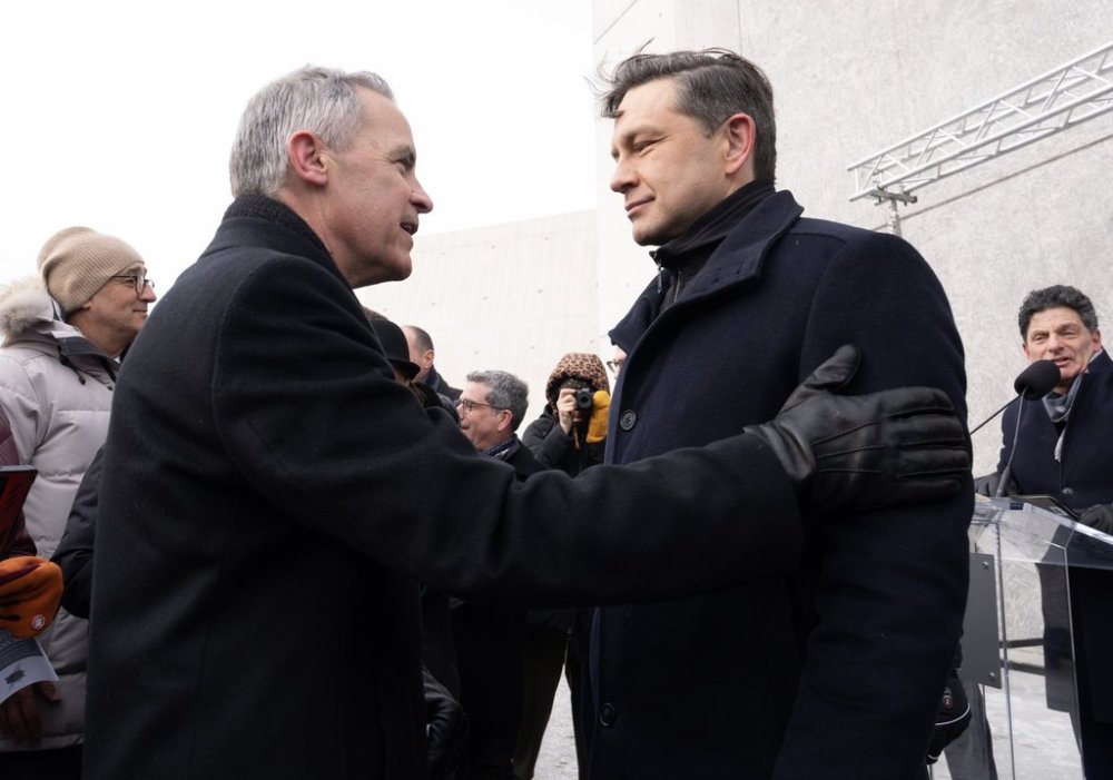 Liberal Leadership candidate Mark Carney speaks with Conservative Leader Pierre Poilievre before a ceremony at the National Holocaust Monument in Ottawa, Monday, Jan 27, 2025. THE CANADIAN PRESS/Adrian Wyld