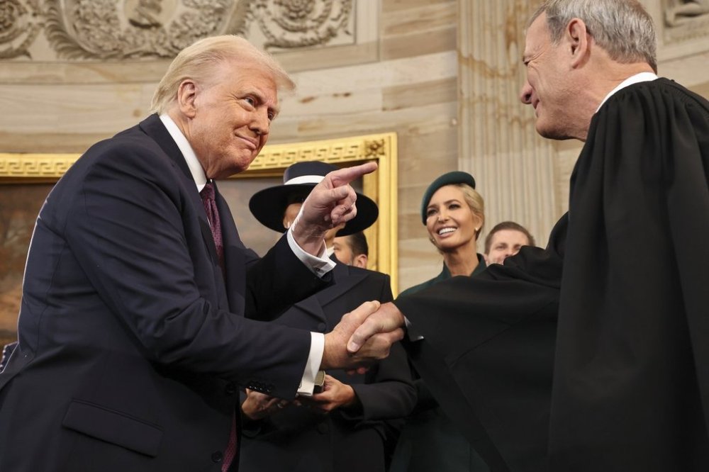 President Donald Trump gestures to Supreme Court Chief Justice John Roberts after being sworn in as president during the 60th Presidential Inauguration in the Rotunda of the U.S. Capitol in Washington, Monday, Jan. 20, 2025. (Chip Somodevilla/Pool Photo via AP)