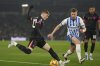 Chelsea's Cole Palmer sends a cross by Brighton's Adam Webster during the English Premier League soccer match between Brighton and Chelsea in Brighton, England, Friday, Feb. 14, 2025. (AP Photo/Dave Shopland)