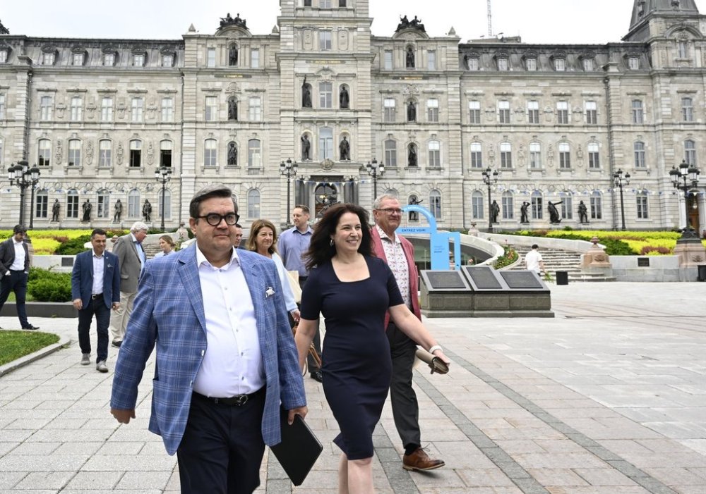 Former MP and Montreal mayor Denis Coderre walks to a news conference with his life partner Annie Pare on Friday, June 21, 2024 in Quebec City. THE CANADIAN PRESS/Jacques Boissinot