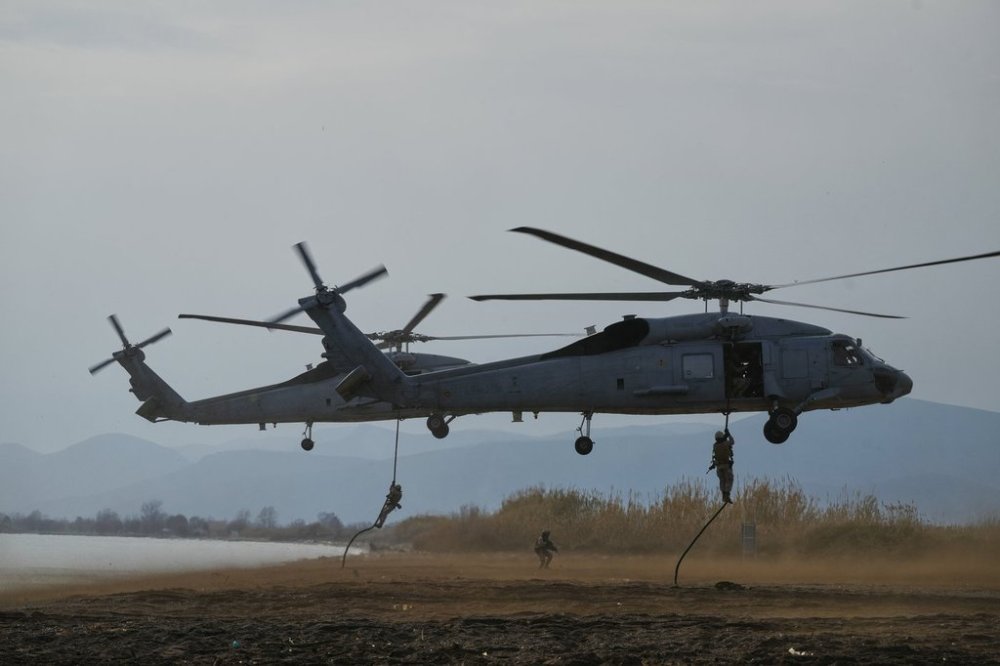 Special forces from Spain land on a beach from a military helicopter as they participate in the Steadfast Dart 2025 exercise, involving some 10,000 troops in three different countries from nine nations and represent the largest NATO operation planned this year, in Nea Anchialos, central Greece, Thursday, Feb. 13, 2025. (AP Photo/Thanassis Stavrakis)