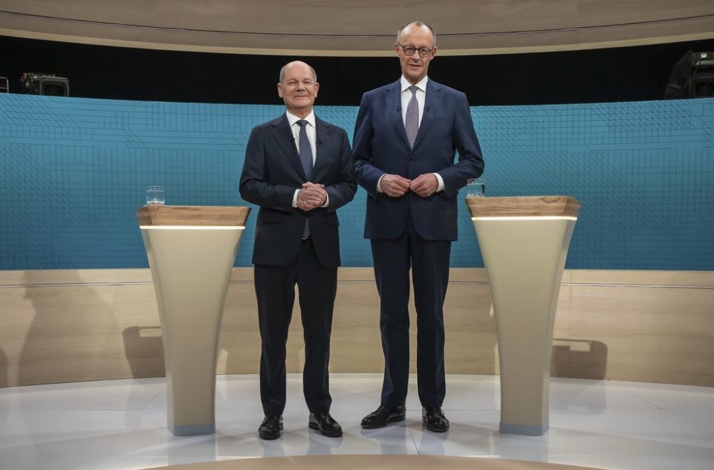 German Chancellor Olaf Scholz, left, and Friedrich Merz, CDU candidate for chancellor before a TV election debate in Berlin, Sunday Feb. 9, 2025. (Michael Kappeler /dpa via AP)