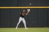 FILE - Pittsburgh Pirates center fielder Michael A. Taylor reaches up to catch a fly out by the Texas Rangers in a baseball game, Aug. 21, 2024, in Arlington, Texas. (AP Photo/Tony Gutierrez, File)