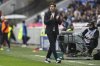 Lyon's head coach Paulo Fonseca walks along the sideline during the French League One soccer match between Lyon and Reims at the Groupama stadium in Decines, outside Lyon, central France, Sunday, Feb. 9, 2025. (AP Photo/Laurent Cipriani)