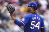 FILE - Texas Rangers pitcher José Ureña calls for a new ball after giving up a two-run home run to Colorado Rockies' Ezequiel Tovar in the first inning of a baseball game, May 12, 2024, in Denver. (AP Photo/David Zalubowski, File)