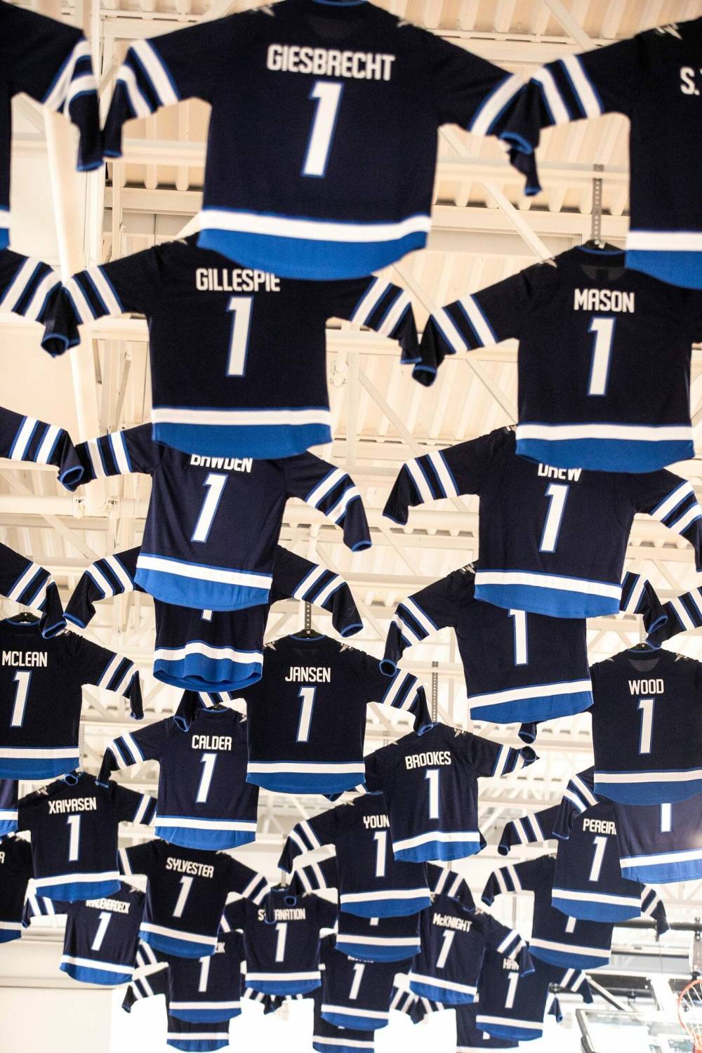 Mikaela MacKenzie / Free Press
                                Jerseys hang from the rafters of the Bruce Oake Recovery Centre, each one signifying someone who has achieved one year of sobriety after having gone through the program.