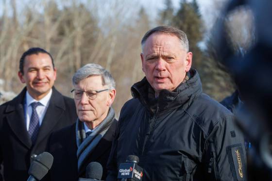Federal Public Safety Minister David McGuinty (right), with Premier Wab Kinew (left) and Terry Duguid, the federal cabinet minister for Prairies Economic Development Canada, talks to the media after meeting with law enforcement officers. (Mike Deal / Free Press)