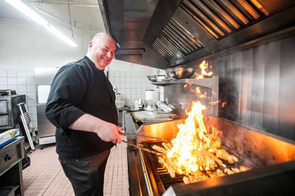 MIKAELA MACKENZIE / FREE PRESS
While many Winnipeggers equate Greek eateries with fatboy burgers, Nick Douklias was determined Helios would stick to more authentic fare such as souvlaki, dolmadakia, saganaki and his mom’s specialty, yemista, a stuffed pepper dish.