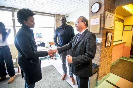 Minister Uzoma Asagwara shakes hands with Park Manor CEO Abednigo Mandalupa before announcing the expansion. (Mikaela MacKenzie / Free Press)