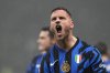 Inter Milan's Marko Arnautovic celebrates after scoring his side's opening goal during an Italian Cup quarter final soccer match between Inter Milan and Lazio, at the San Siro stadium in Milan, Italy, Tuesday, Feb. 25, 2025. (AP Photo/Luca Bruno)