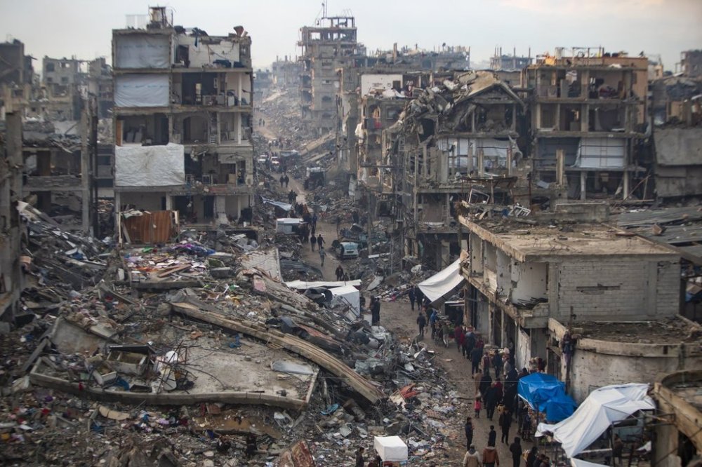 Palestinians walk in the destruction caused by the Israeli air and ground offensive in Jabaliya, Gaza Strip, Tuesday, Feb. 11, 2025. (AP Photo/Jehad Alshrafi)
