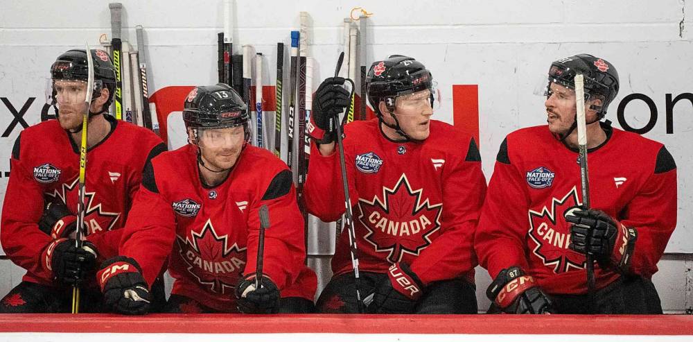 Canada players (left to right) Connor McDavid, Sam Reinhart, Nathan MacKinnon and Sidney Crosby talk on the bench during 4 Nations Face-Off hockey practice in Montreal on Monday. (Christinne Muschi/The Canadian Press)