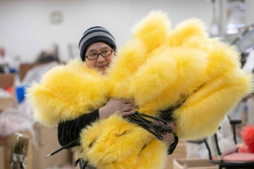 BROOK JONES/FREE PRESS
                                Longtime Wonderful World of Sheepskin employee Phung Dinh carries a number of lambswool dusters as he walks through its Winnipeg factory at 250 Dufferin Ave.