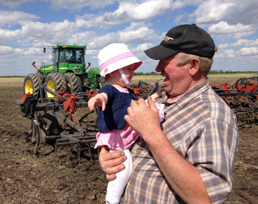 Campbell with his granddaughter Madison on the farm.