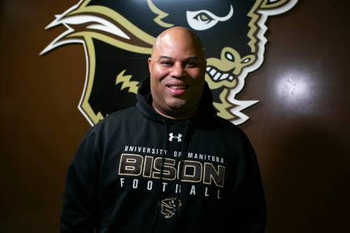 BROOK JONES/FREE PRESS
                                The University of Manitoba Bisons football team&rsquo;s newly minted head coach Stan Pierre, 53, is pictured in front of a Bison logo at Princess Auto Stadium.