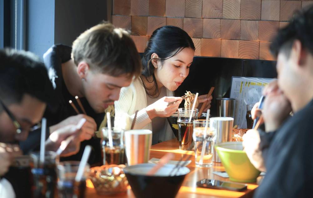 Ruth Bonneville / Free Press
Kinton Ramen customer Renata Moura (centre) lunches with a group of colleagues Friday.