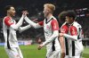 Frankfurt's Hugo Larsson, second left, celebrates after scoring the opening goal during the German Bundesliga soccer match between Eintracht Frankfurt and Holstein Kiel in Frankfurt, Germany, Sunday, Feb. 16, 2025. (Arne Dedert/dpa via AP)