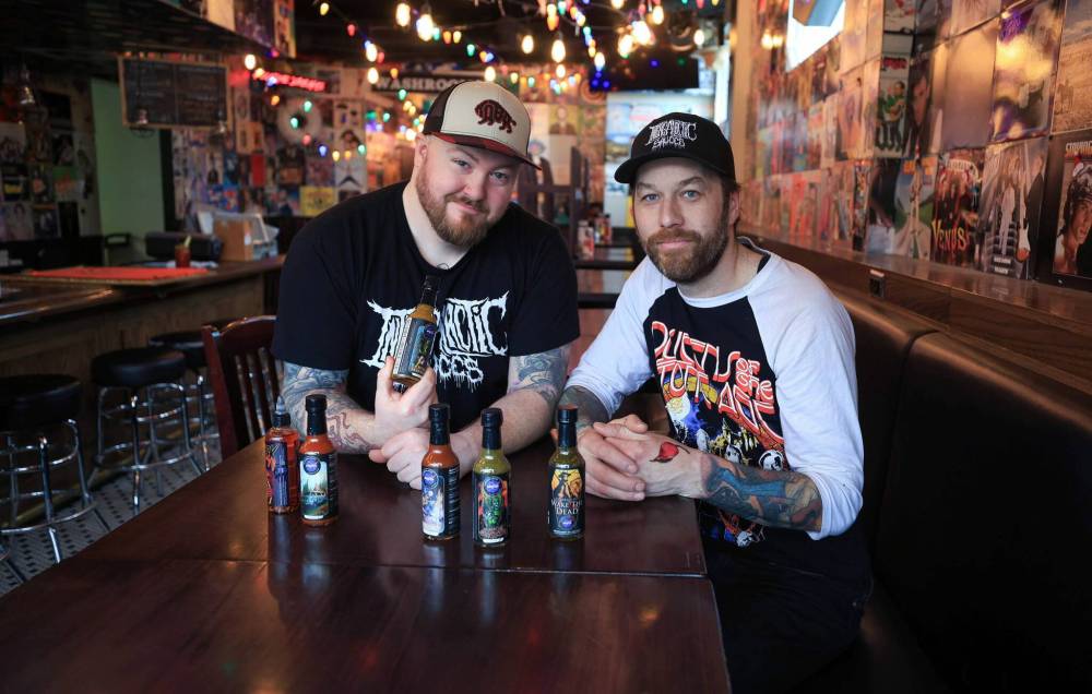 RUTH BONNEVILLE / FREE PRESS
Intergalactic Sauces co-owners Dan Trupp (left) and Josh Ayers show off their range
of small-batch hot sauces.