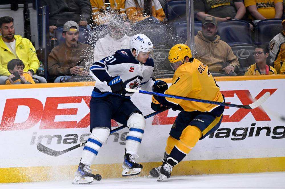 John Amis / The Associated Press
Winnipeg Jets’ Cole Perfetti and Nashville Predators’ Marc Del Gaizoo battle along the boards during the first period.