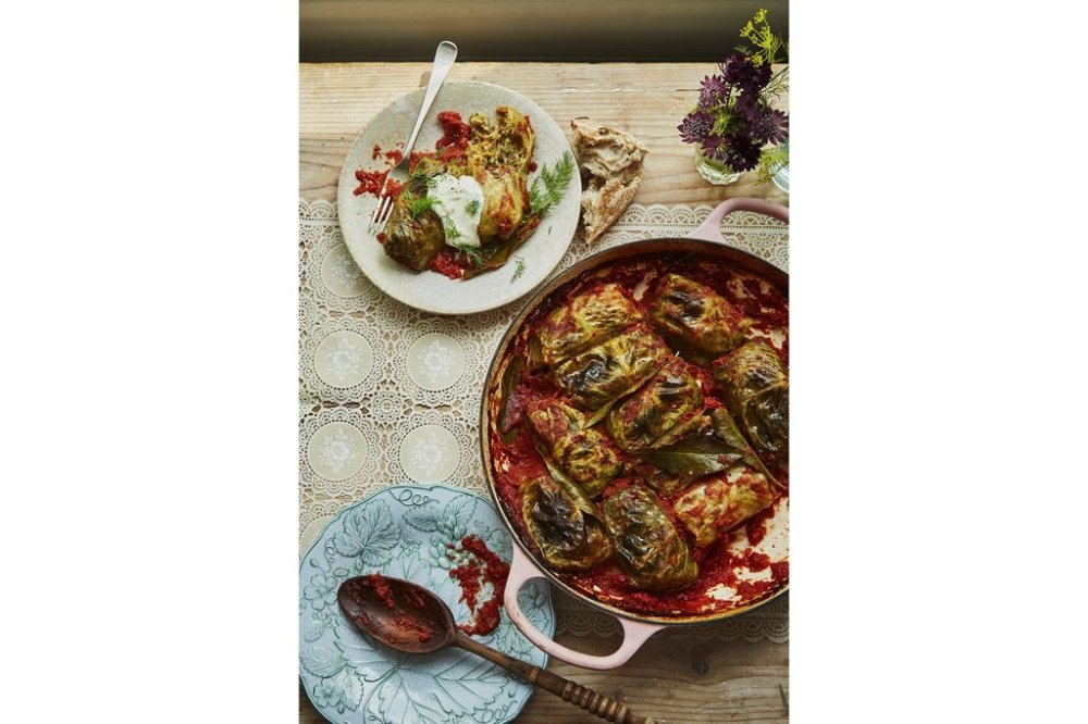 This image released by Quadrille, Penguin Random House UK shows a recipe for cabbage rolls with sauerkraut leaves, beef and rice in a tomato sauce, from the cookbook