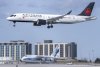 An Air Canada flight lands in front of a Russian-registered Antonov AN-124 owned by Volga-Dneper at Pearson Airport in Toronto, Monday, March 21, 2022. THE CANADIAN PRESS/Frank Gunn