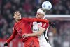 Jamal Musiala of Munich, left, and Rasmus Kristensen of Frankfurt in action during the Bundesliga soccer match between Bayern Munich and Eintracht Frankfurt at the Allianz Arena, Munich, Germany, Sunday Feb. 23, 2025. (Sven Hoppe/dpa via AP)