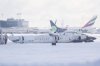 A Delta Air Lines plane lies upside down at Toronto Pearson Airport on Tuesday, Feb. 18, 2025. Airport officials say operations are 
