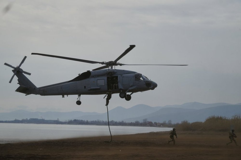 Special forces from Spain land on a beach from a military helicopter as they participate in the Steadfast Dart 2025 exercise, involving some 10,000 troops in three different countries from nine nations and represent the largest NATO operation planned this year, in Nea Anchialos, central Greece, Thursday, Feb. 13, 2025. (AP Photo/Thanassis Stavrakis)