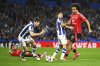 Manchester United's Joshua Zirkzee, right, challenges for the ball with Real Sociedad's Takefusa Kubo during the Europa League round of 16 first leg soccer match between Real Sociedad and Manchester United at the Reale Arena in San Sebastian, Spain, Thursday, March 6, 2025. (AP Photo/Miguel Oses)