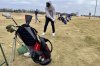 Golfers line up to take some practice shots on the driving range of the Stone Creek Golf Course in Omaha, Neb. on Monday afternoon, March 3, 2025, before hitting the links. (AP Photo/Margery Beck)