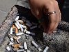 A smoker puts out a cigarette in a public ash tray in Ottawa on May 31, 2016. THE CANADIAN PRESS/Sean Kilpatrick
