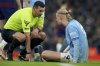 Referee Andy Madley checks on Manchester City's Erling Haaland after he injured himself during the English Premier League soccer match between Manchester City and Newcastle United at Etihad stadium in Manchester, England, Saturday, Feb. 15, 2025. (AP Photo/Ian Hodgson)