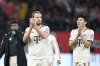 Bayern's Harry Kane and Bayern's Kim Min-jae, right, applaud supporters at the end of the German Bundesliga soccer match between Bayer Leverkusen and FC Bayern Munich at the BayArena in Leverkusen, Germany, Saturday, Feb. 15, 2025. (AP Photo/Martin Meissner)