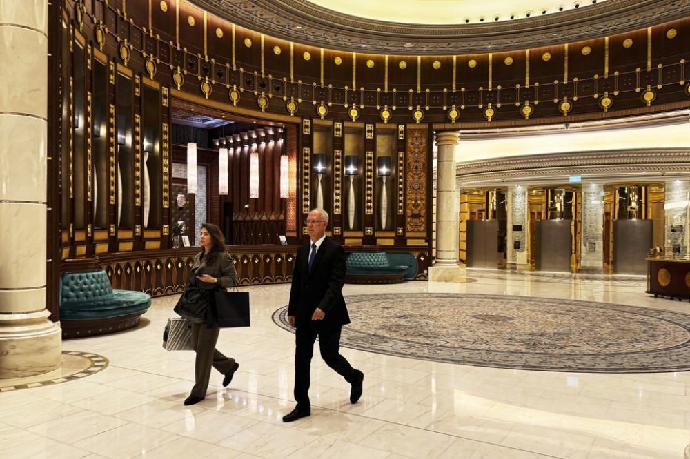Kirill Dmitriev, the head of the Russian Direct Investment Fund, right, and Maria Medvedeva, the deputy CEO for external communication for the fund, walk across the Ritz Carlton hotel in Riyadh, Saudi Arabia, Tuesday, Feb. 18, 2025. (AP Photo/Baraa Anwer)